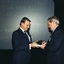 John Moule presenting book to a man