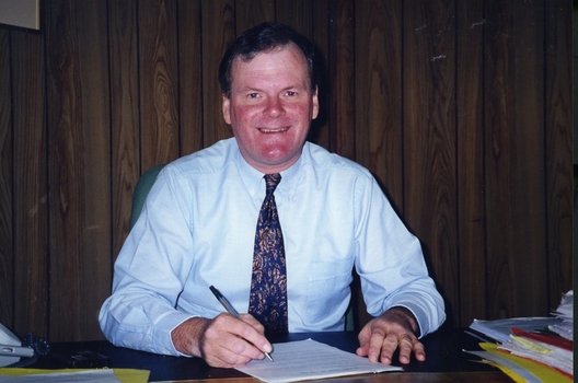 Geoff Melvin, Board Lawyer, at a desk