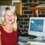 Tracey Millwood laughs as she turns from her desk