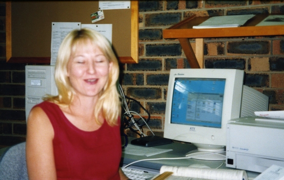 Tracey Millwood laughs as she turns from her desk