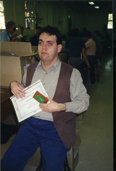 Michael Box holding Jenny Scown's certificate and QBIC frog award
