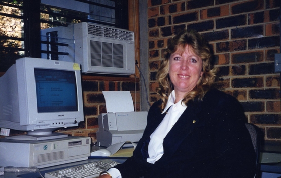 Sue Camps sitting at a computer screen