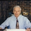 Peter Lynam at a desk at Vision QLD