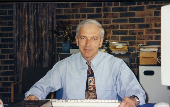 Peter Lynam at a desk at Vision QLD