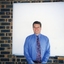Nigel Irwin in front of a projector screen