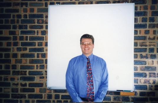 Nigel Irwin in front of a projector screen