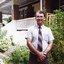Dene Vilkins, Project Co-ordinator and Assistant Manger, standing outside a house