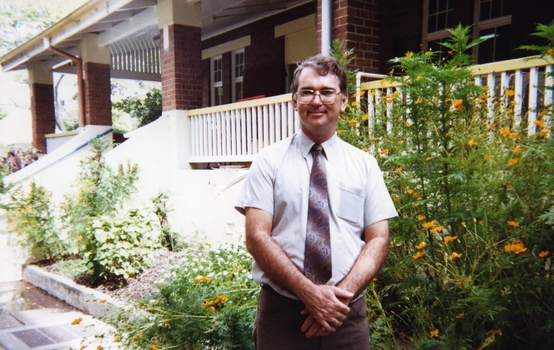 Dene Vilkins, Project Co-ordinator and Assistant Manger, standing outside a house