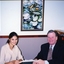 Geoff Melvin passing a document to a unidentified female