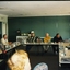 Group of people seated at tables set in open rectangle layout