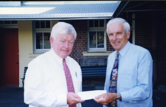 Tim Quinn handing cheque to Peter Lynam