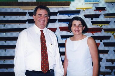 John Puttick stands with Anna Bligh in front of brush head wall