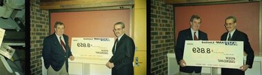 John Puttick receiving a cheque from an AMP representative