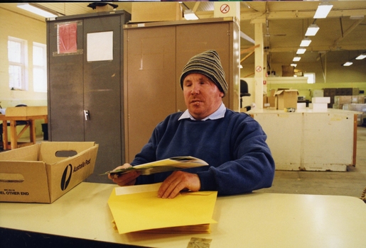 Unidentified staff member stuffing envelopes