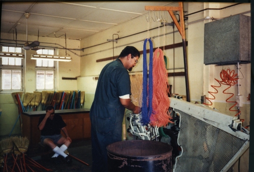 Alan Nemeth making brooms in the factory