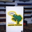 QBIC frog log in front of display rack of broom heads