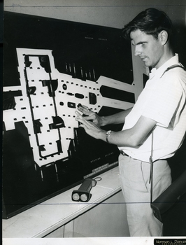 Man stands as he reads a tactile map of Wynyard station