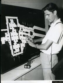 Man stands as he reads a tactile map of Wynyard station