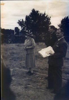 Three people standing in a field