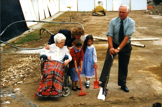 Mary Tiernan and her family look on as Rex Hollioake turns the sod