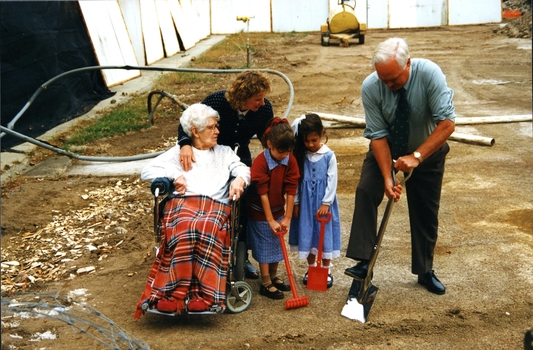Mary Tiernan and her family look on as Rex Hollioake turns the sod