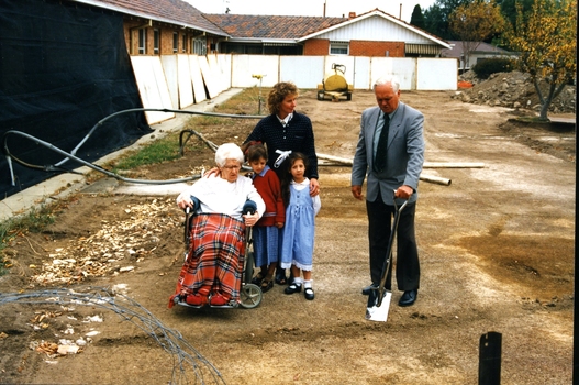 Mary Tiernan and her family look on as Rex Hollioake turns the sod