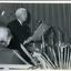 Sir Delacombe at podium giving speech