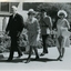 Sir and Lady Delacombe walk the grounds with Kitty Rose and another person