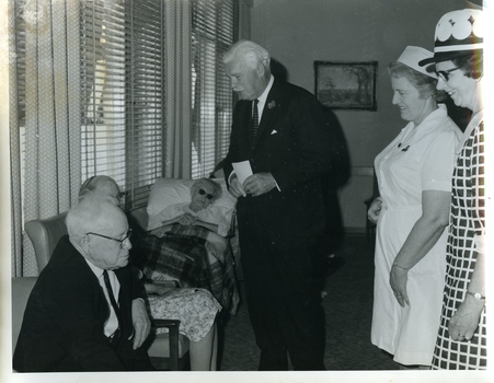 Sir Rohan speaking with residents as Matron and Kitty Rose look on
