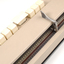 Beige rectangle box with cream buttons and braille display