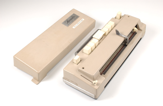 Beige rectangle box with cream buttons and silver return lever