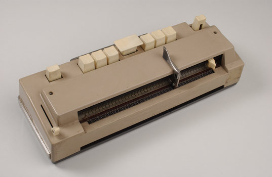 Beige rectangle box with cream buttons and silver return lever