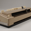 Beige rectangle box with cream buttons and silver return lever
