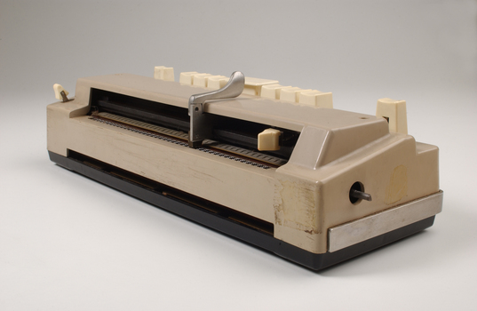Beige rectangle box with cream buttons and silver return lever