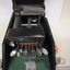 Seven silver oval keys attached to black vinyl covered device inside black box