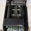 Seven silver oval keys attached to black vinyl covered device inside black box