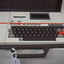 Cream keyboard with brown keys, 'Keynote' written on side, red line and cassette unit above keys