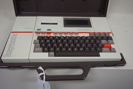 Cream keyboard with brown keys, 'Keynote' written on side, red line and cassette unit above keys