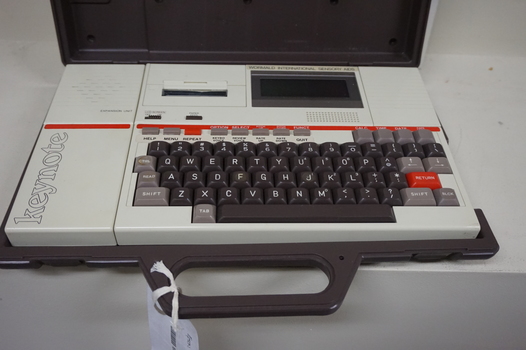 Cream keyboard with brown keys, 'Keynote' written on side, red line and cassette unit above keys