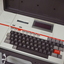 Cream keyboard with brown keys, 'Keynote' written on side, red line and cassette unit above keys