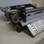 Metal rectangular plates joined with metal keys and connecting puncher that moves across the page