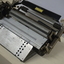 Metal rectangular plates joined with metal keys and connecting puncher that moves across the page