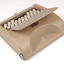 Tan case with flip top lid exposing keyboard, and red handle strap
