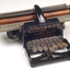 Black brailler with metal keys and wooden roller