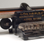 Black brailler with metal keys and wooden roller