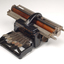 Black brailler with metal keys and wooden roller