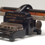 Black brailler with metal keys and wooden roller