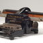 Black brailler with metal keys and wooden roller
