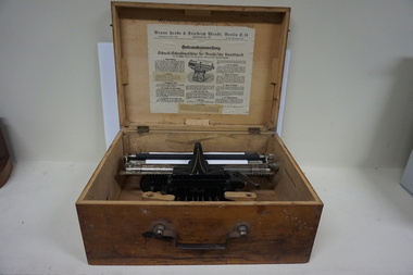 Wooden box with metal Braille typewriter