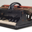 Piano like keyboard on black iron base with metal rollers